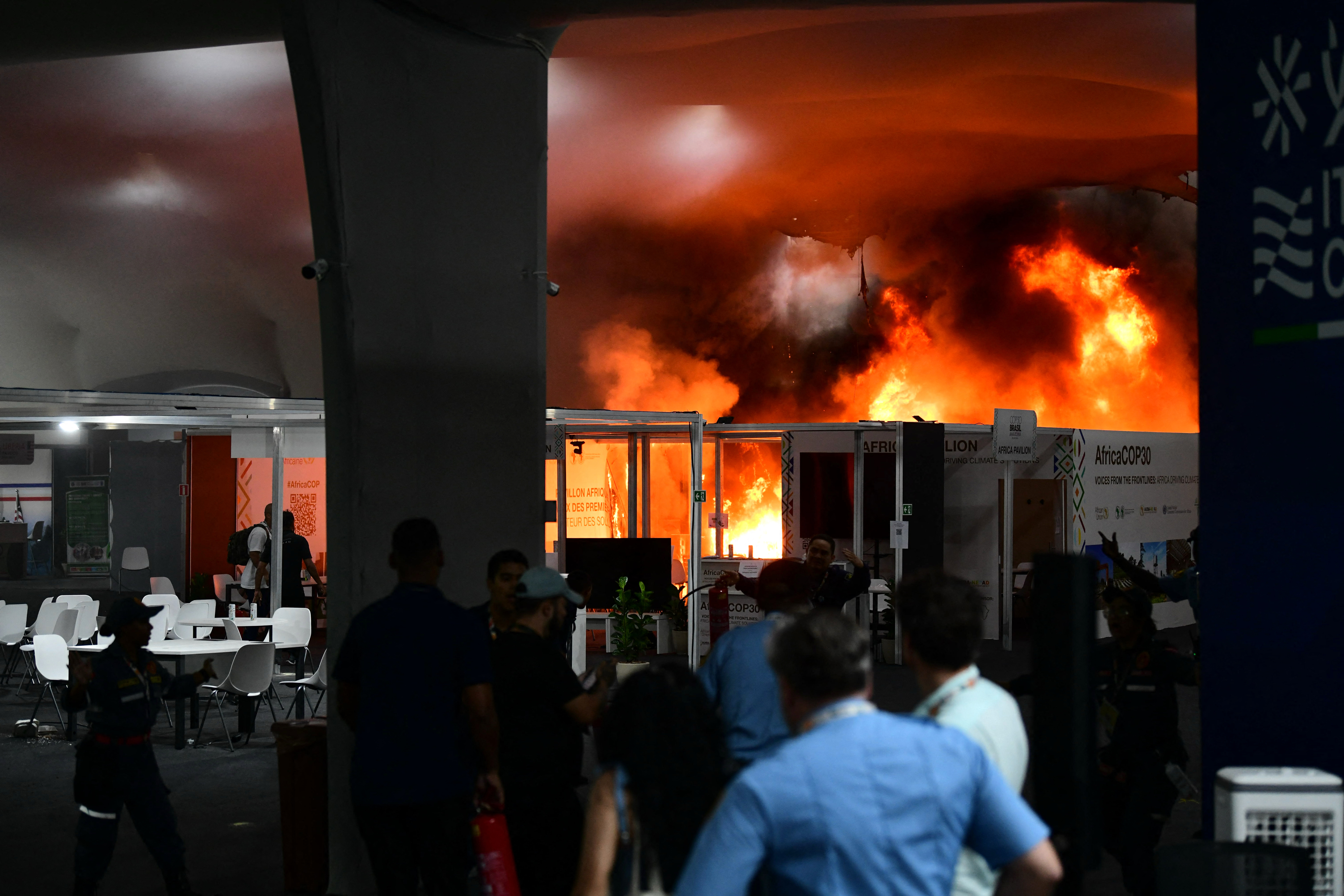 A fire burns in a pavilion during the COP30 UN Climate Change Conference in Belem